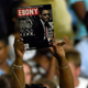 A supporter holds up an issue Ebony magazine featuring Barack Obama before a speech at a campaign event billed as a town hall meeting August 19, 2008.